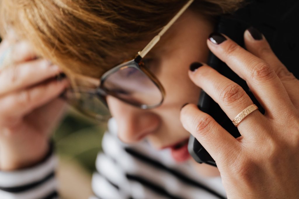 A women distressed while on the phone.