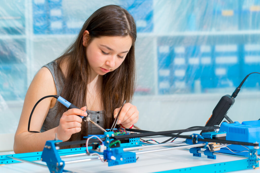 Schoolgirl in the classroom design and development of robots