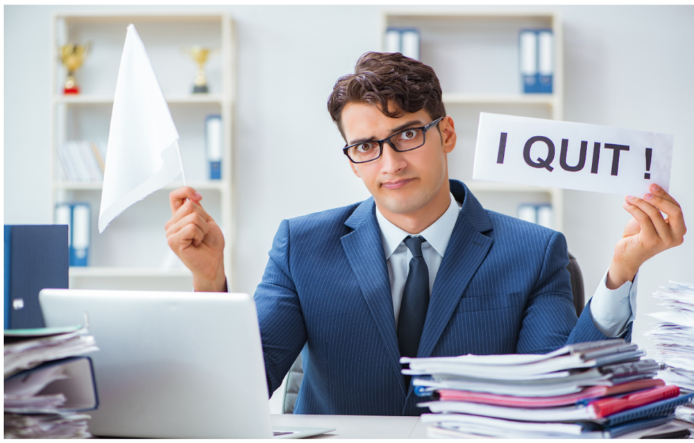 Software developer holding sign that says I quit