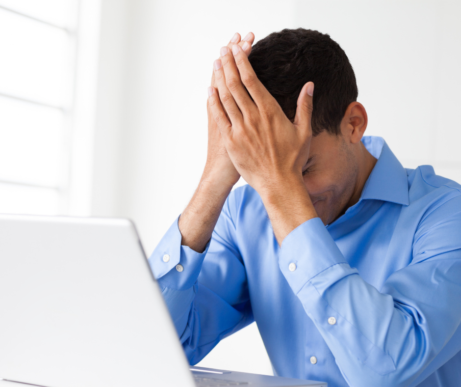 A man frustrated while working at his computer.